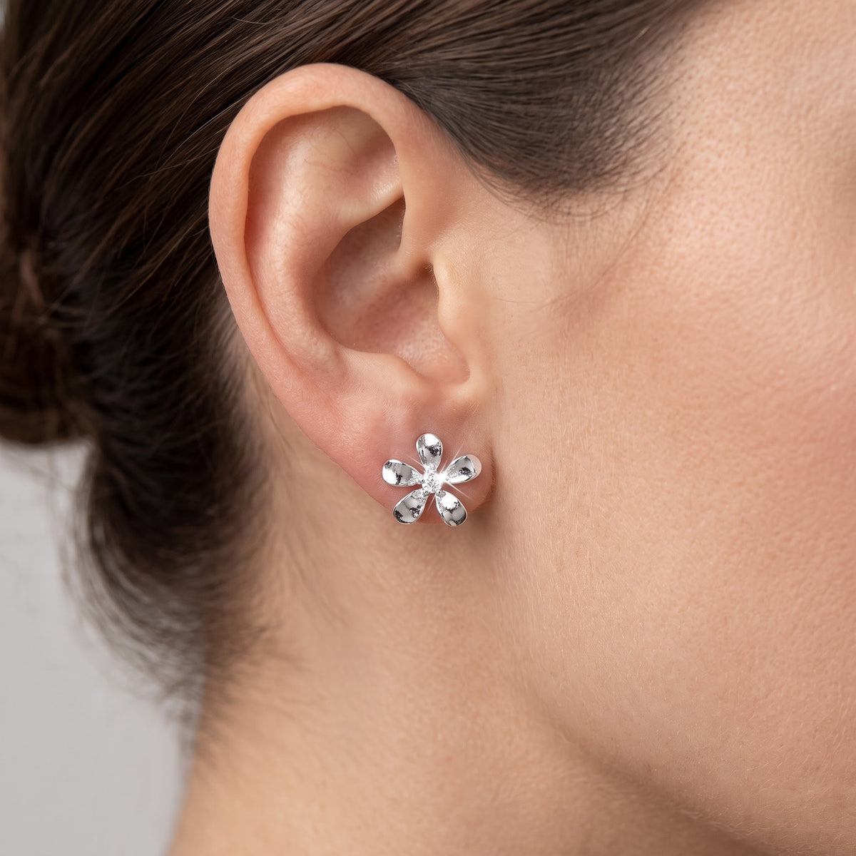 Sterling Silver Plumeria Flower Stud Earrings - 9mm worn, lifestyle photo