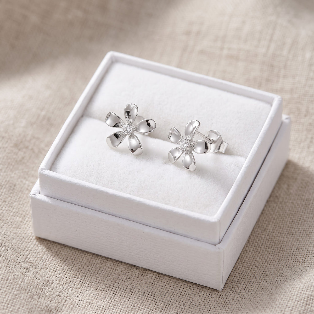 Sterling Silver Plumeria Flower Stud Earrings - 9mm in a white gift box, ready to give