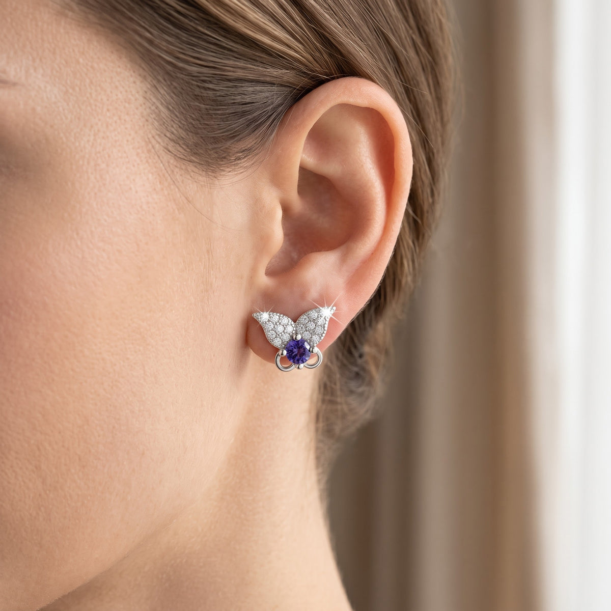 Sterling Silver Purple CZ Butterfly Stud Earrings worn, lifestyle photo