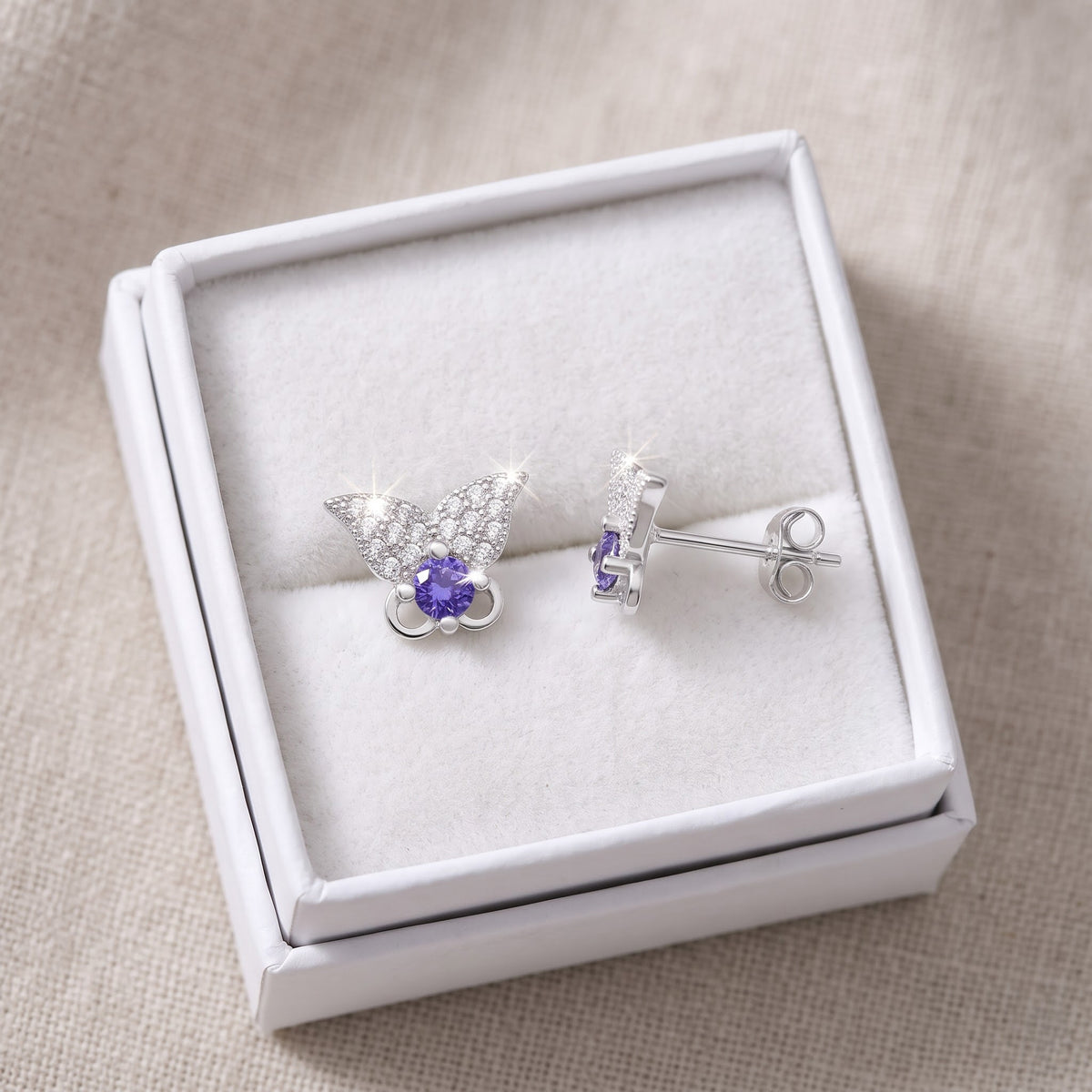 Sterling Silver Purple CZ Butterfly Stud Earrings in a white gift box, ready to give