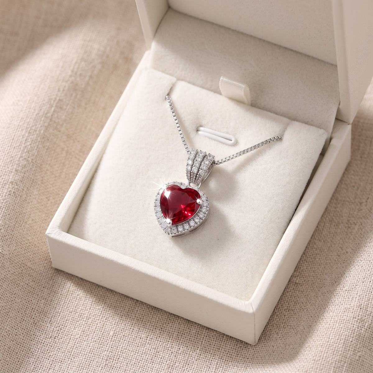 Sterling Silver Red CZ Halo Heart Necklace in a white gift box, ready to give