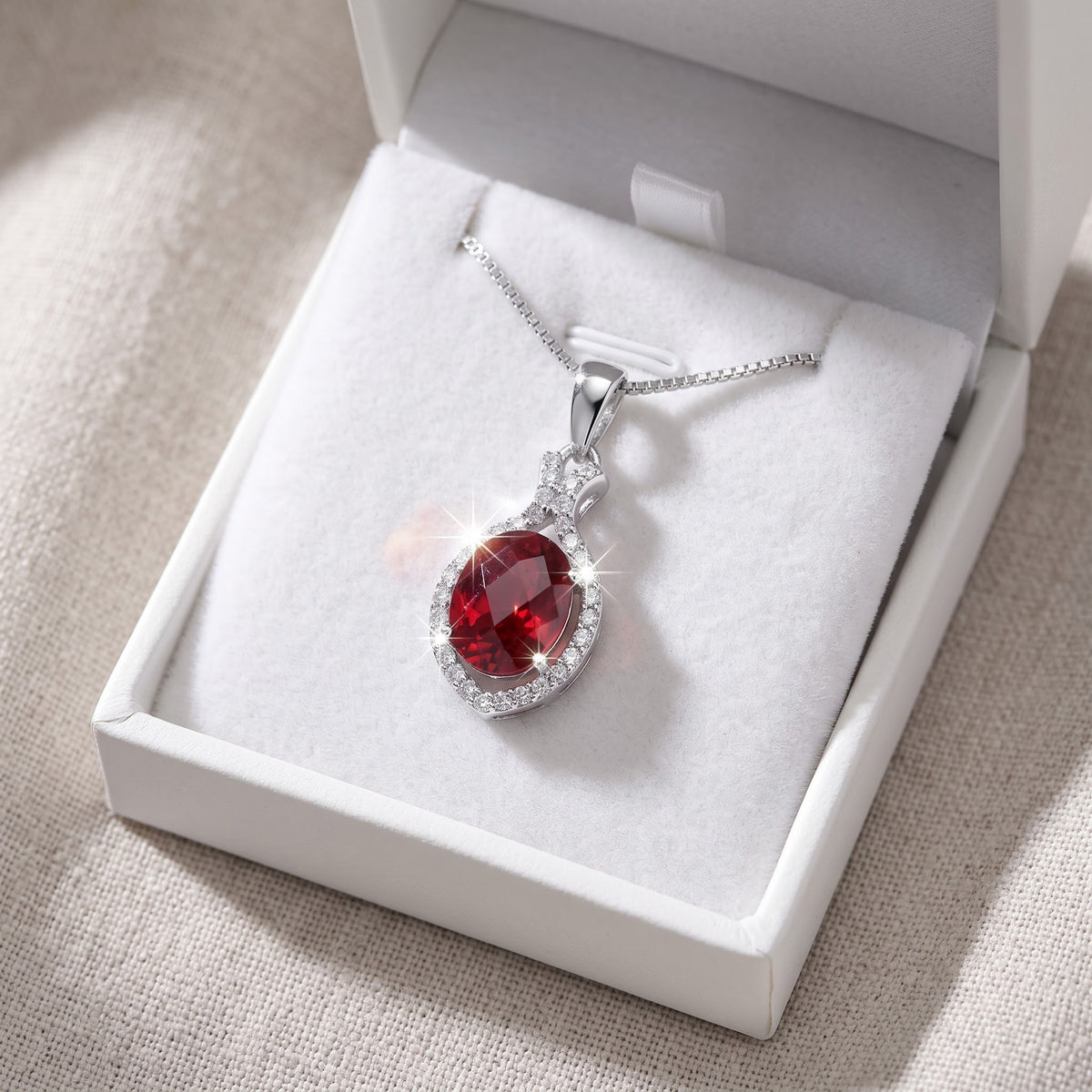 Sterling Silver Red CZ Oval Drop Necklace in a white gift box, ready to give