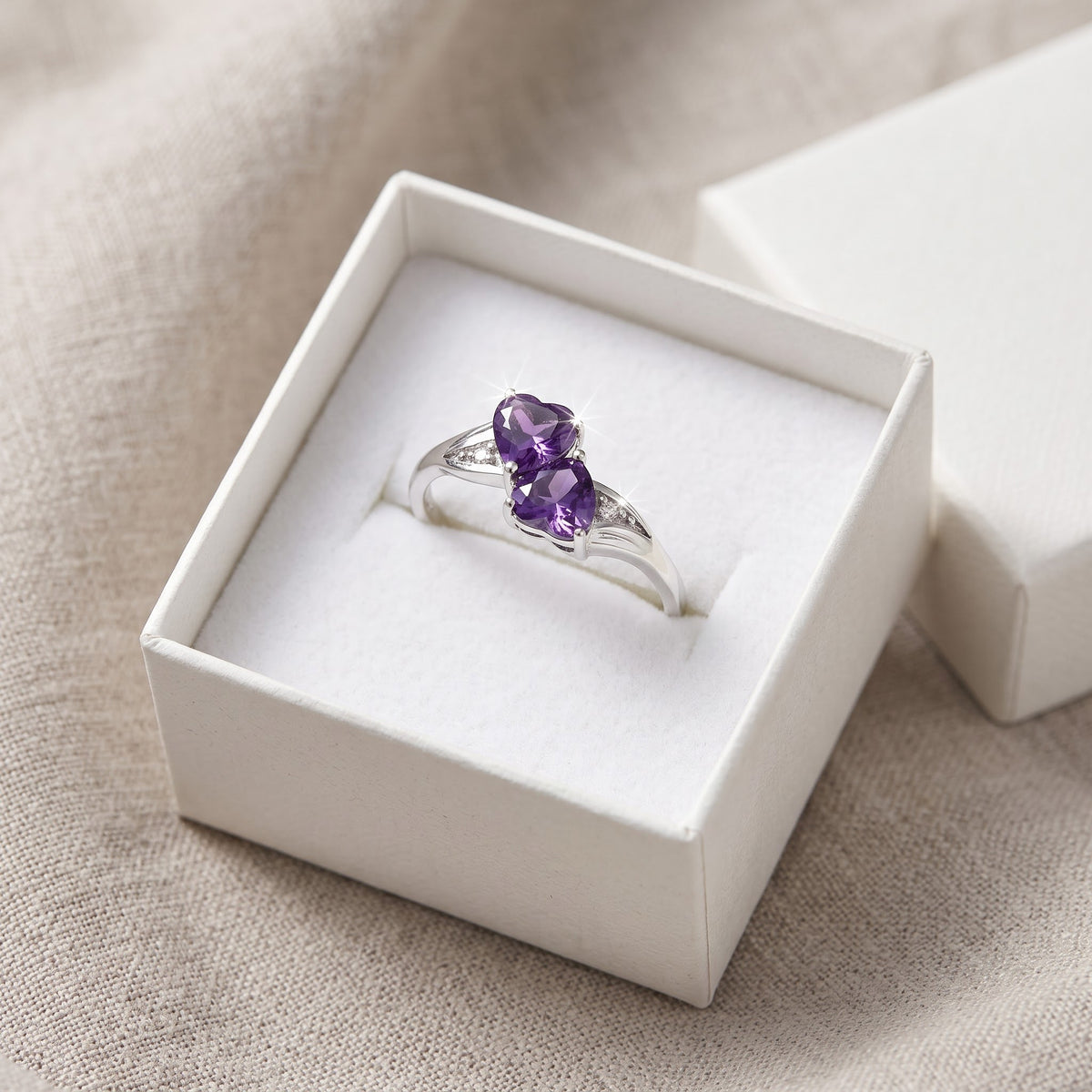 Sterling Silver Simulated Amethyst Double Heart Ring in a white gift box, ready to give