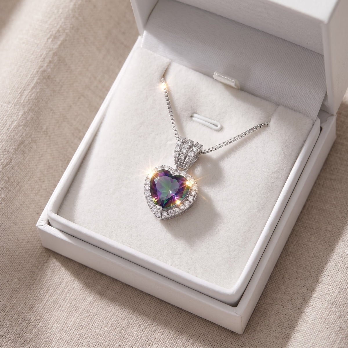 Sterling Silver Simulated Rainbow Topaz Halo Heart Necklace in a white gift box, ready to give