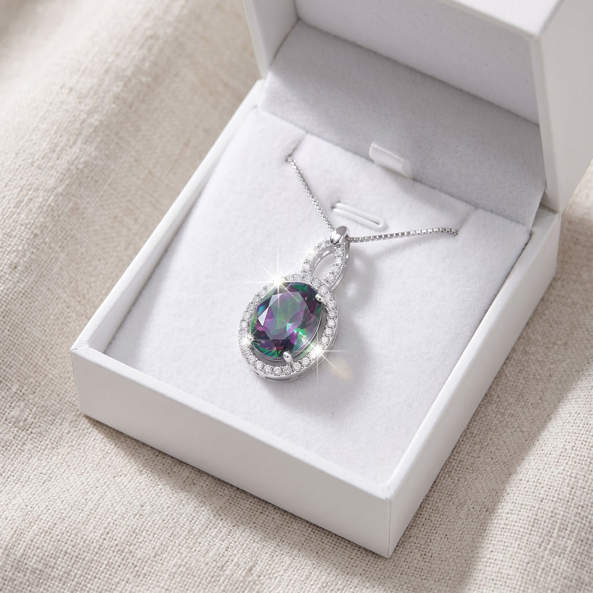 Sterling Silver Simulated Rainbow Topaz Oval Drop Necklace in a white gift box, ready to give
