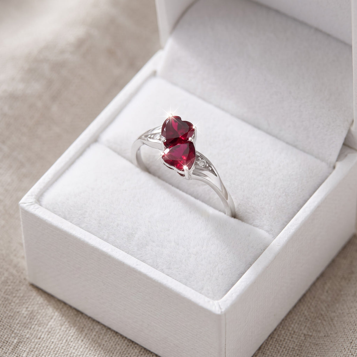 Sterling Silver Simulated Ruby Double Heart Ring in a white gift box, ready to give