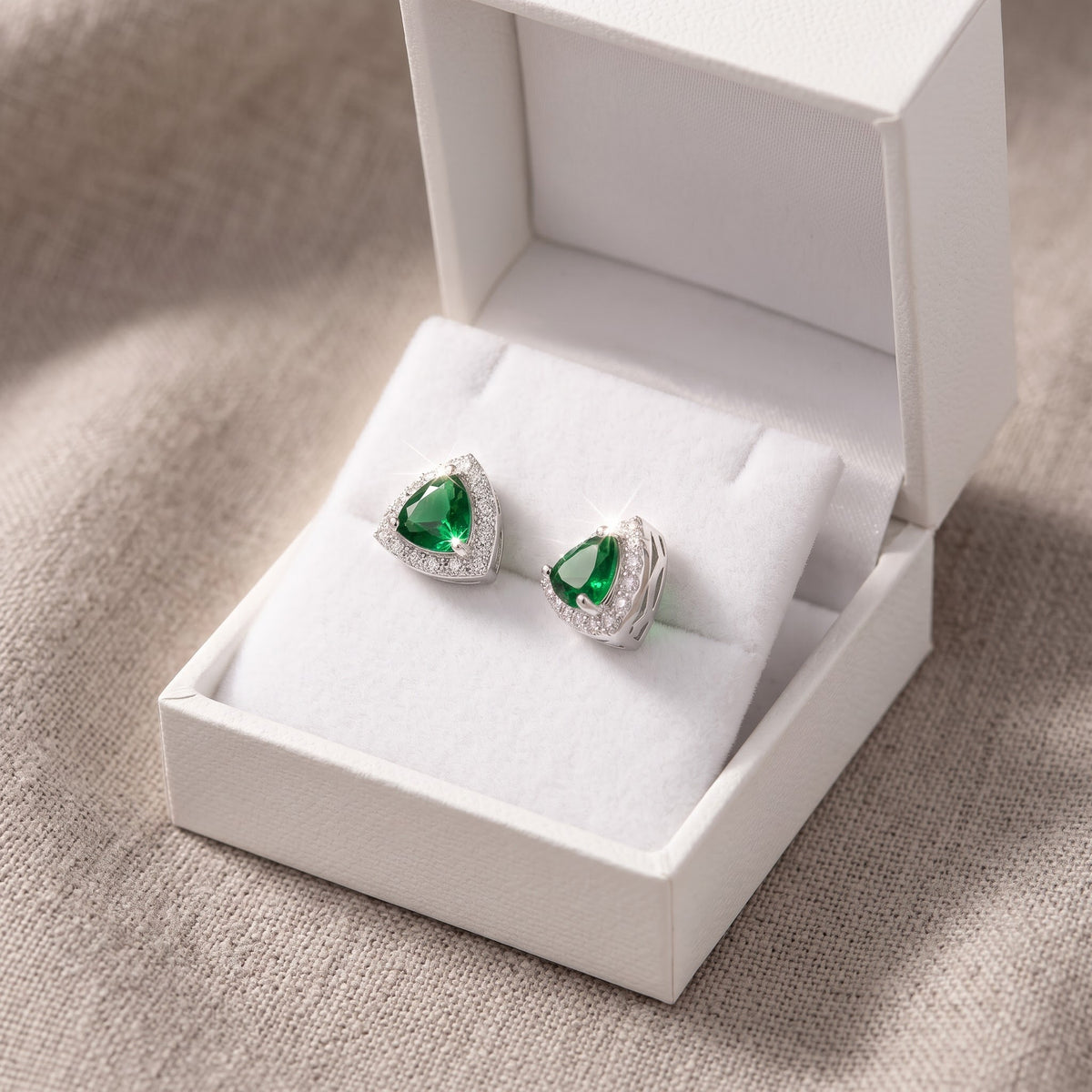 Sterling Silver Simulated Trillion Green Emerald Halo Stud Earrings, 9mm in a white gift box, ready to give