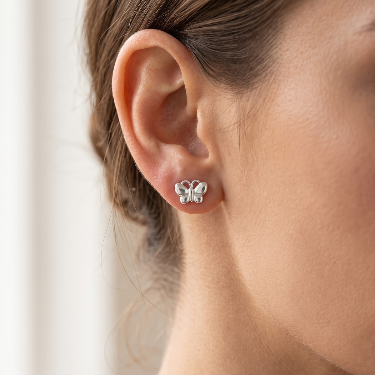 Sterling Silver Girls Small Butterfly Stud Earrings, 8mm worn, lifestyle photo