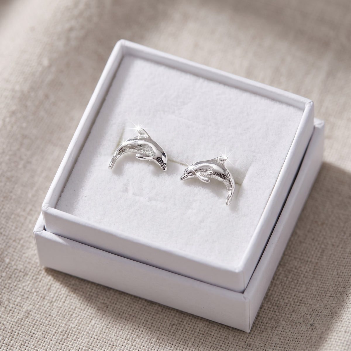 Sterling Silver Small Dolphin Stud Earrings - 8mm in a white gift box, ready to give