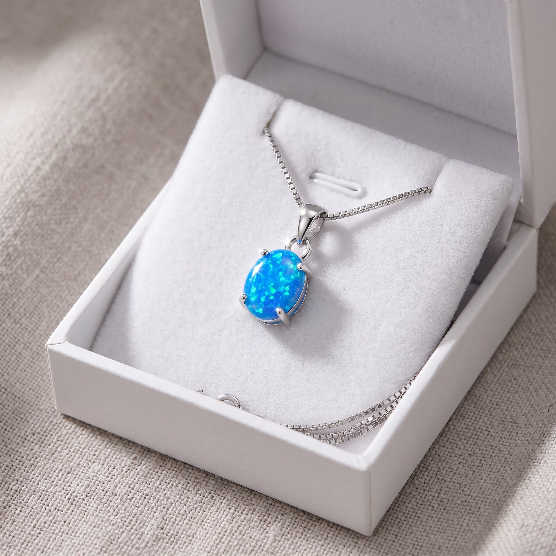Sterling Silver Small Oval Created Blue Opal Necklace 18" in a white gift box, ready to give