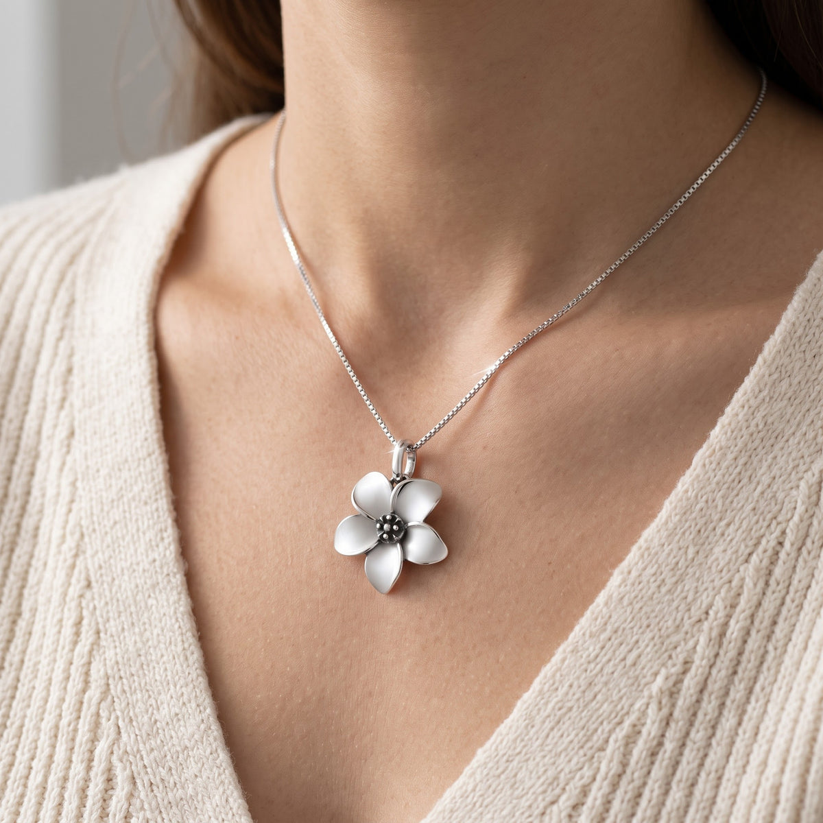 Sterling Silver Small Plumeria Flower Necklace, 18 Inch Chain worn, lifestyle photo