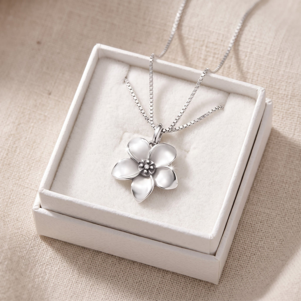 Sterling Silver Small Plumeria Flower Necklace, 18 Inch Chain in a white gift box, ready to give