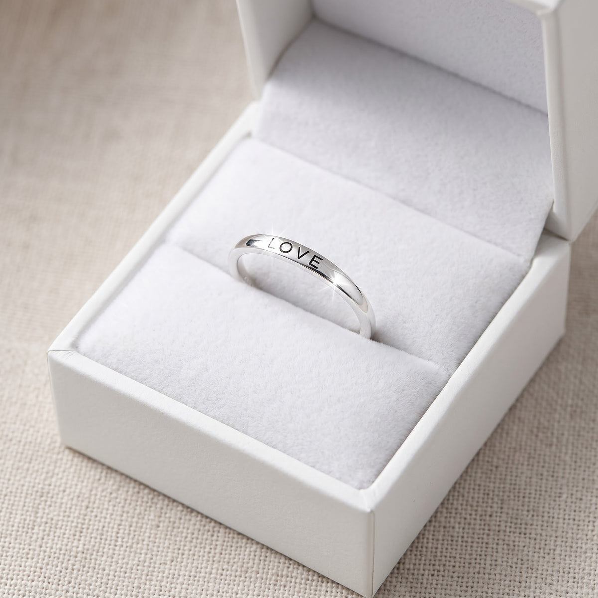 Sterling Silver Thin Stackable Love Ring in a white gift box, ready to give