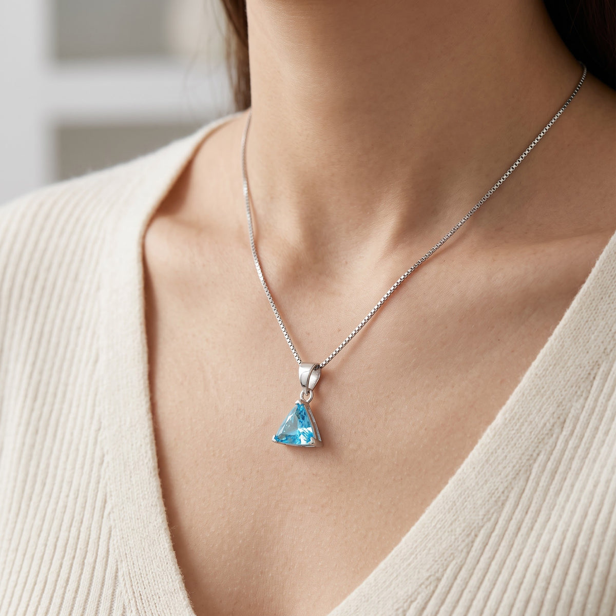 Sterling Silver Triangle Blue CZ Solitaire Necklace worn, lifestyle photo