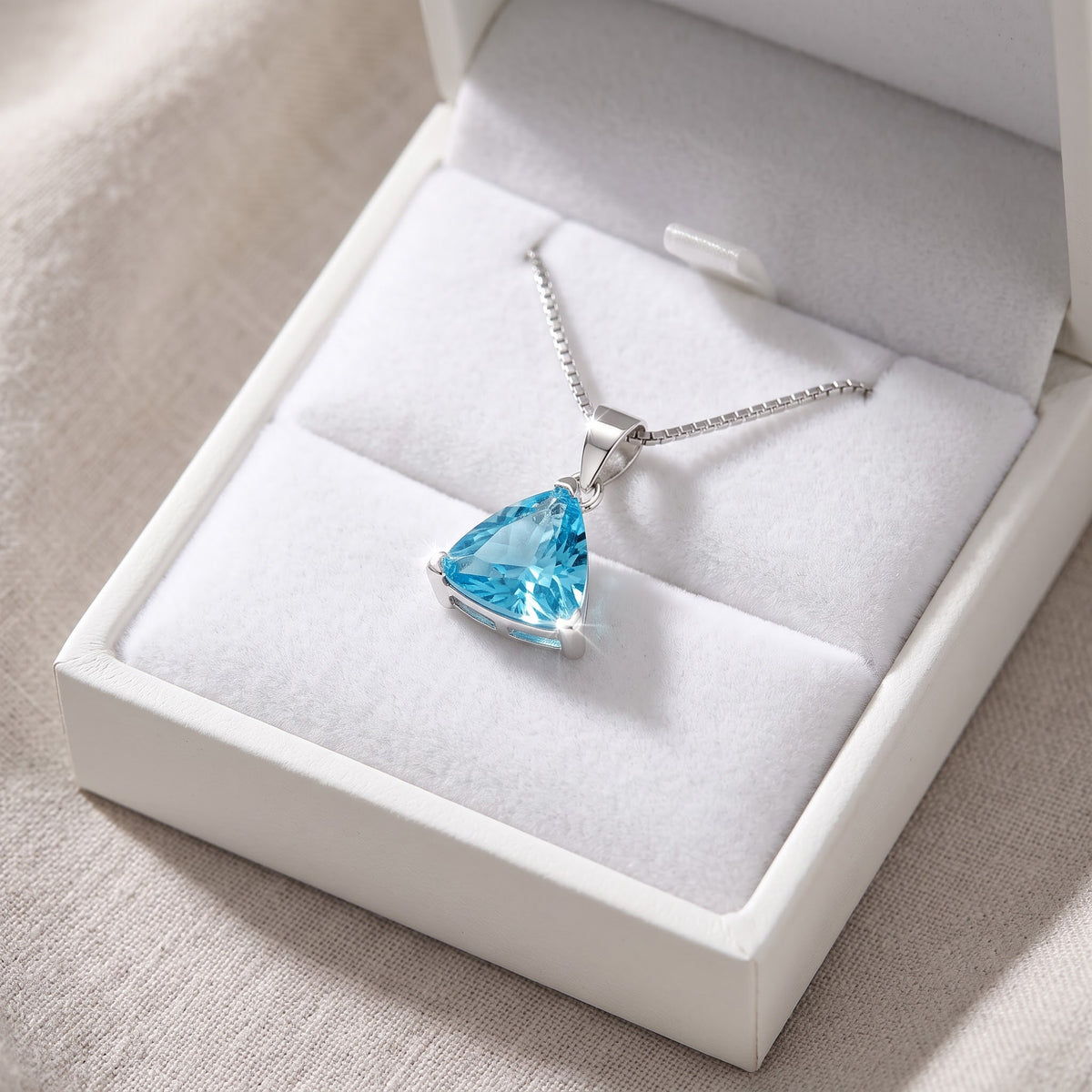 Sterling Silver Triangle Blue CZ Solitaire Necklace in a white gift box, ready to give