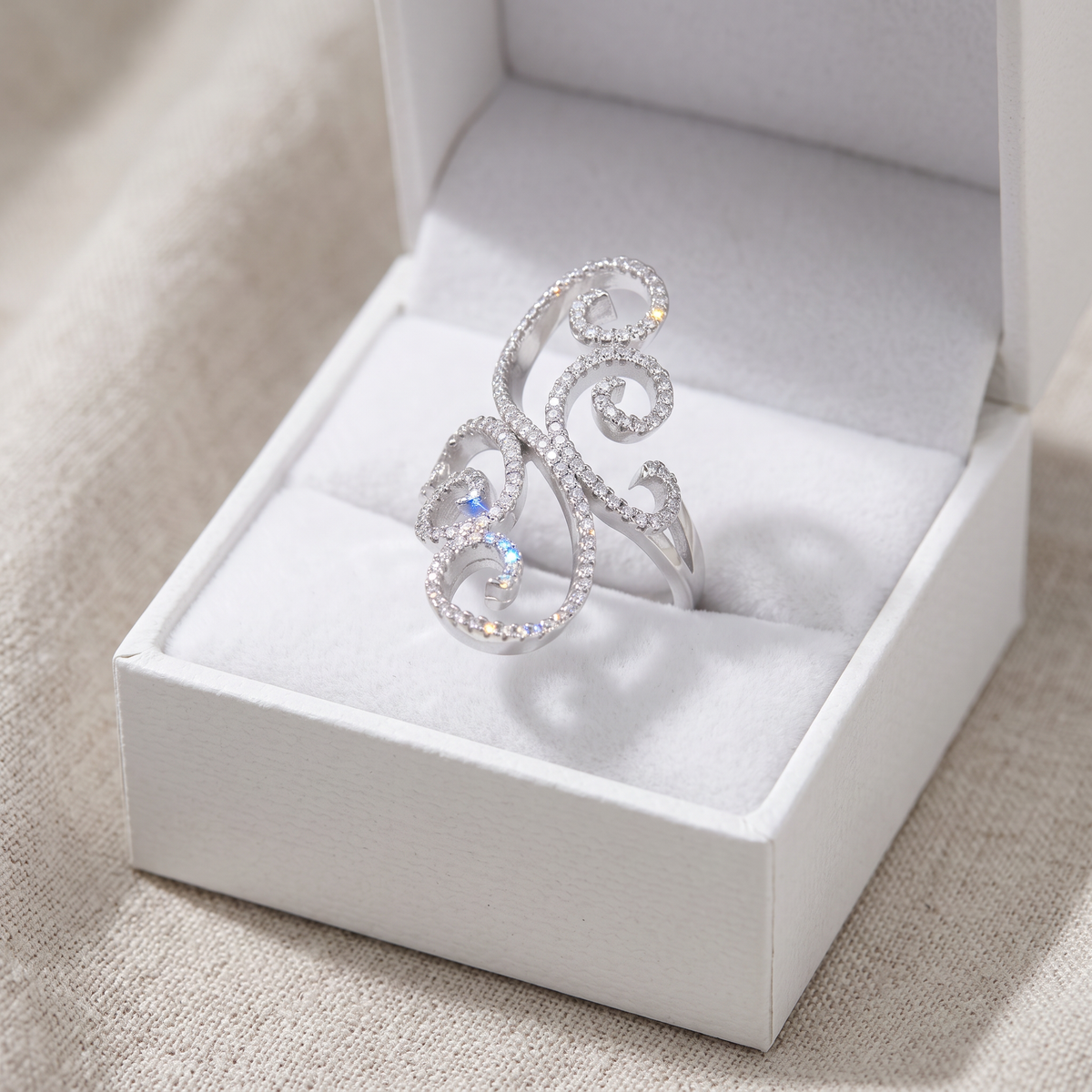 Sterling Silver CZ Open Swirl Filigree Statement Ring in a white gift box, ready to give