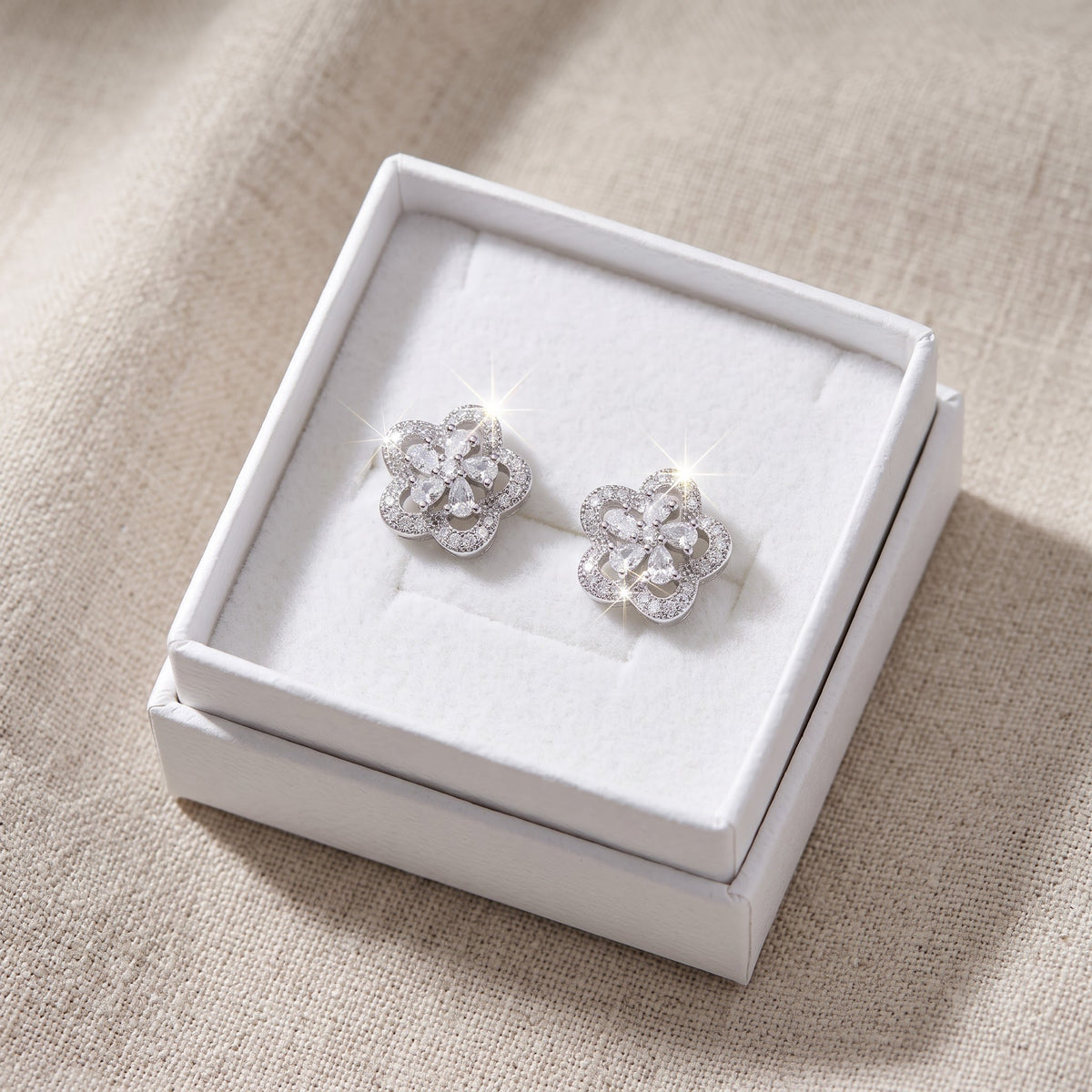 White Gold over Sterling Silver Women's CZ Halo Flower Stud Earrings in a white gift box, ready to give