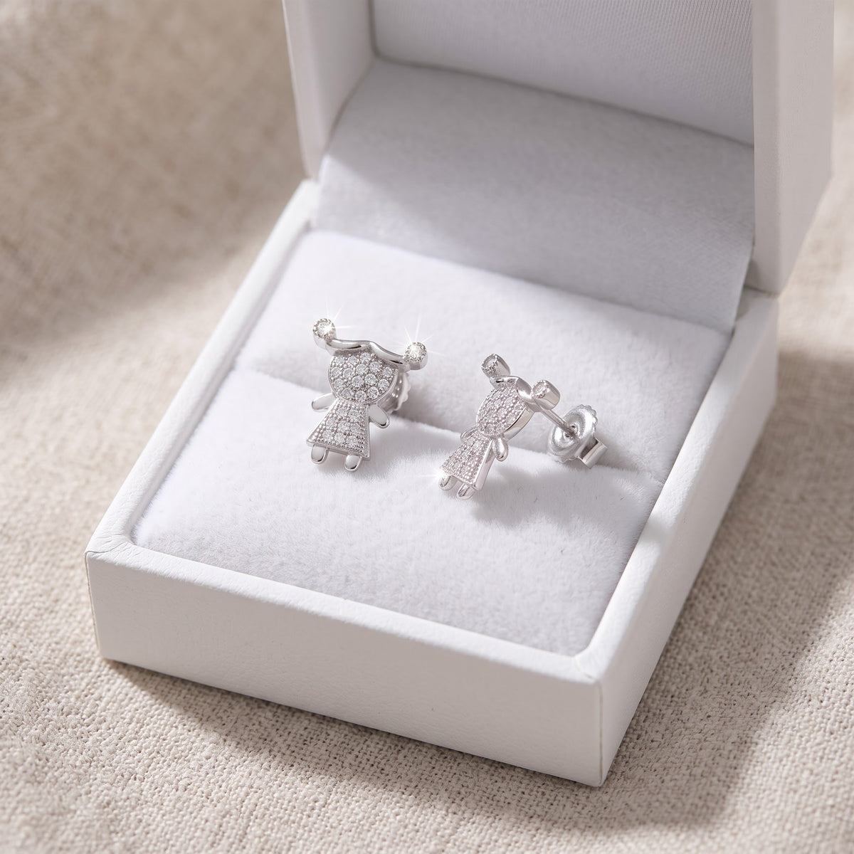 White Gold over Sterling Silver Women's CZ pigtail Girl Stud Earrings in a white gift box, ready to give