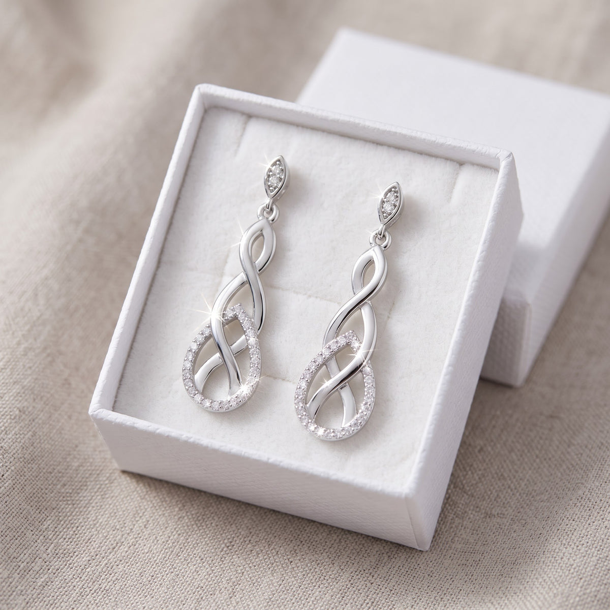 White Gold over Sterling Silver Women's Elegant CZ Celtic Braid Dangle Earrings in a white gift box, ready to give
