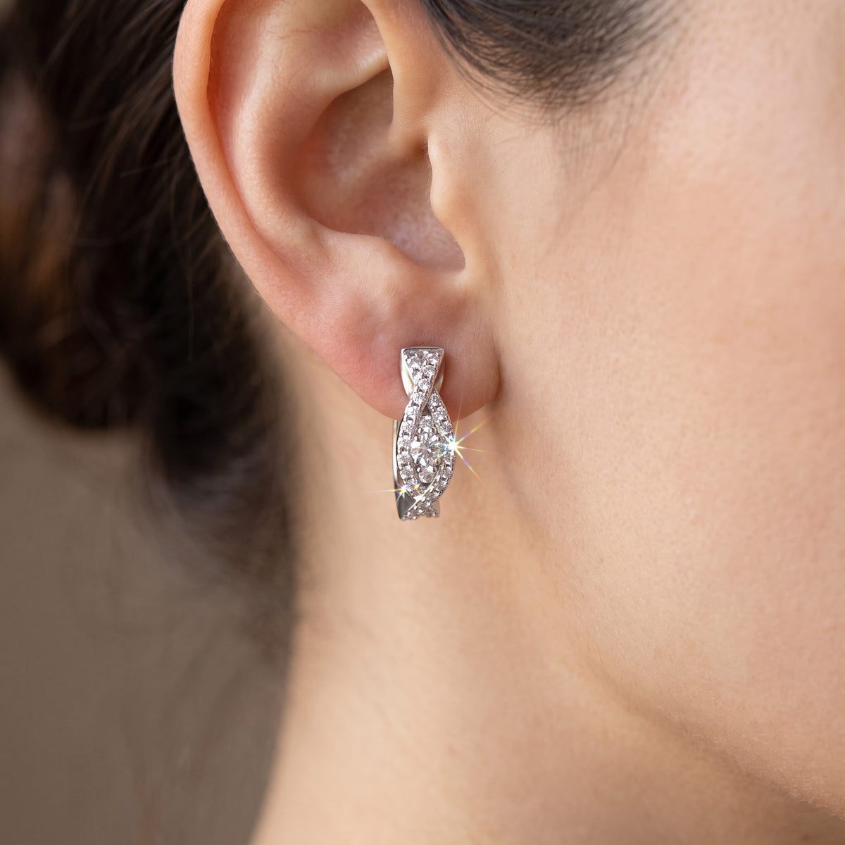 White Gold over Sterling Silver Women's Small CZ Huggie Earrings worn, lifestyle photo