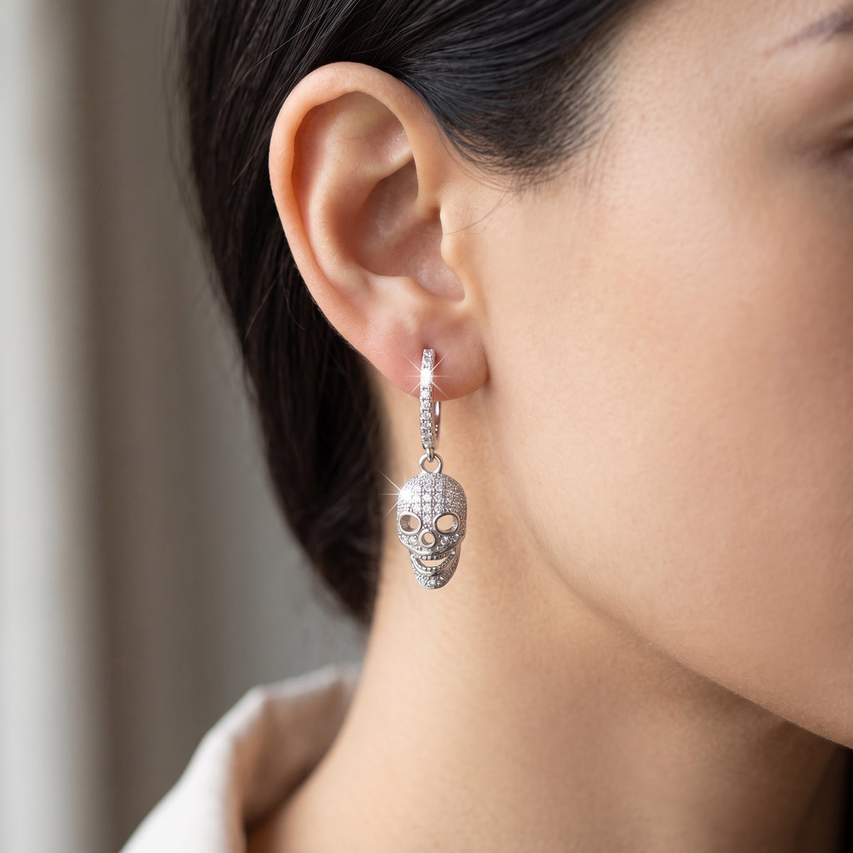 White Gold over Sterling Silver Women's Sugar Skull CZ Dangle Earrings worn, lifestyle photo
