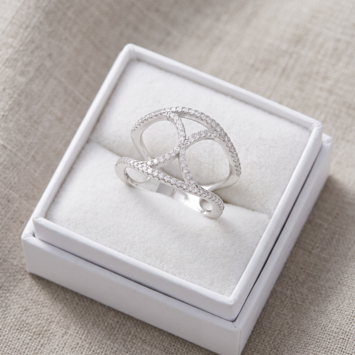 White Gold over Sterling Silver Ladies Wide X CZ Statement Ring in a white gift box, ready to give