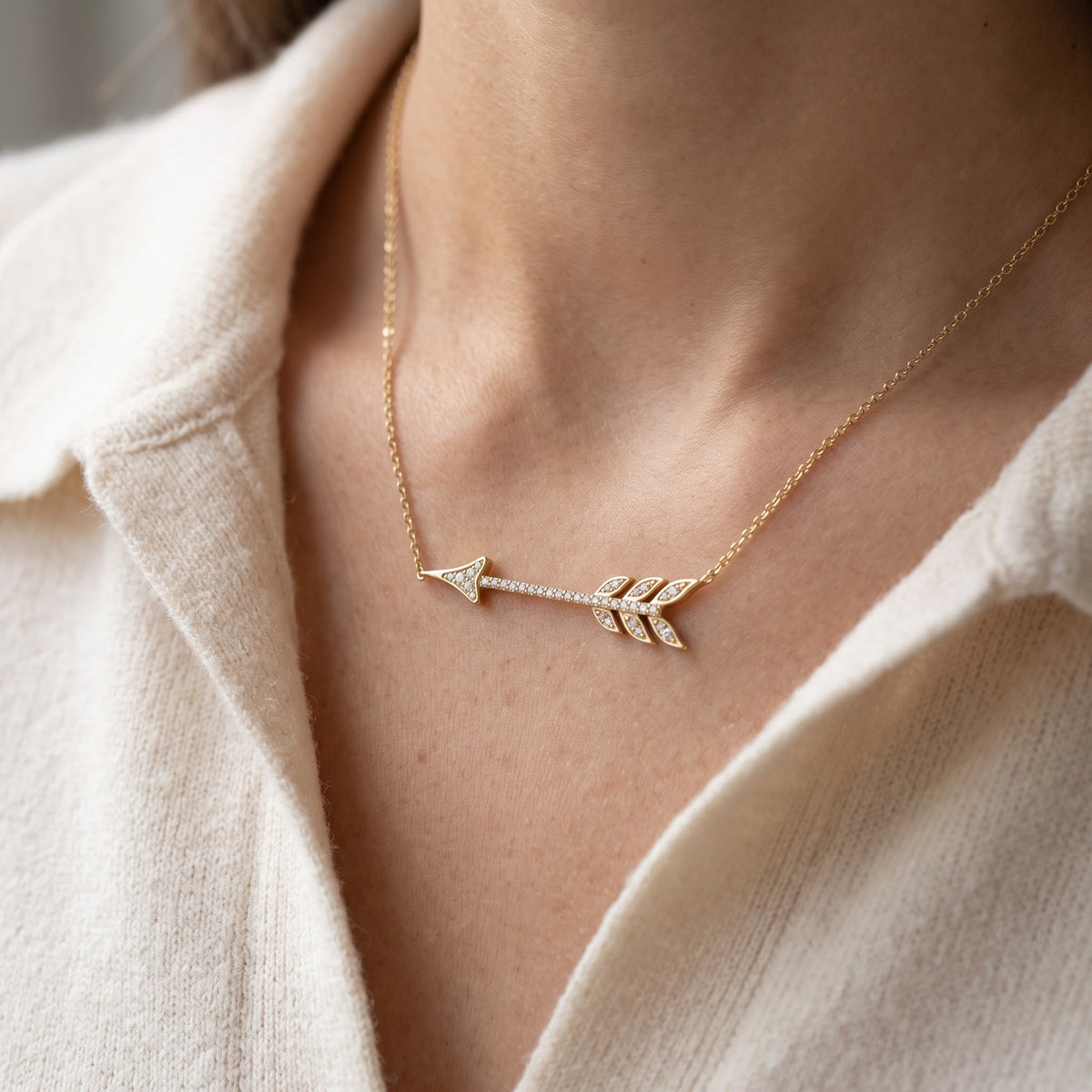 Yellow Gold Tone Sterling Silver CZ Sideways Arrow Necklace, 18" worn, lifestyle photo